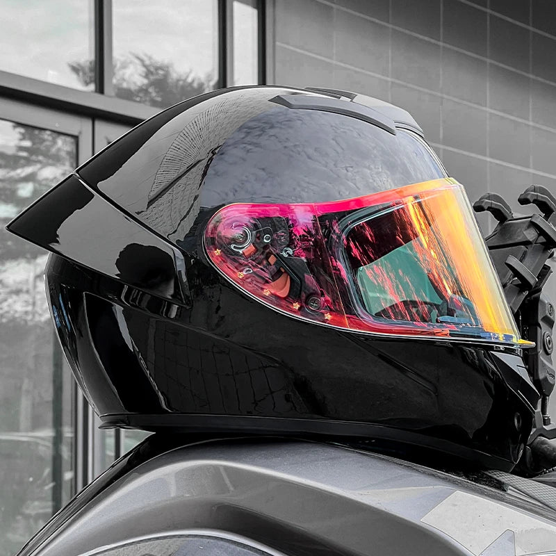 Black motorcycle helmet with colourful visor on a motorcycle