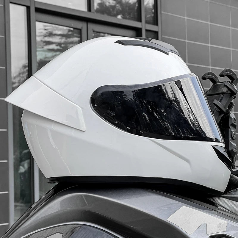 White motorcycle helmet on a motorcycle with a building in the background